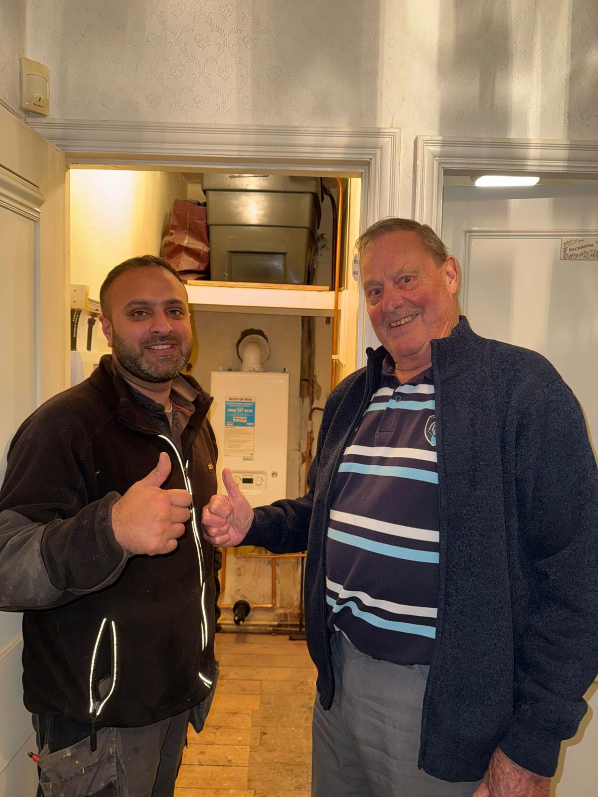 Satisfied homeowner with Emergency Boilers technician after fixing boiler issue