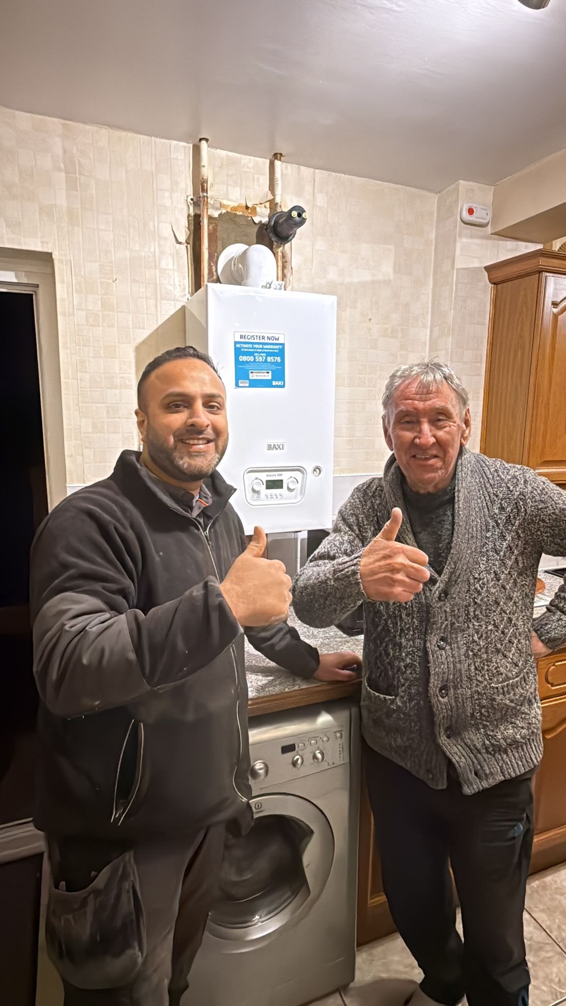 Customer smiling with boiler engineer after successful repair by Emergency Boilers